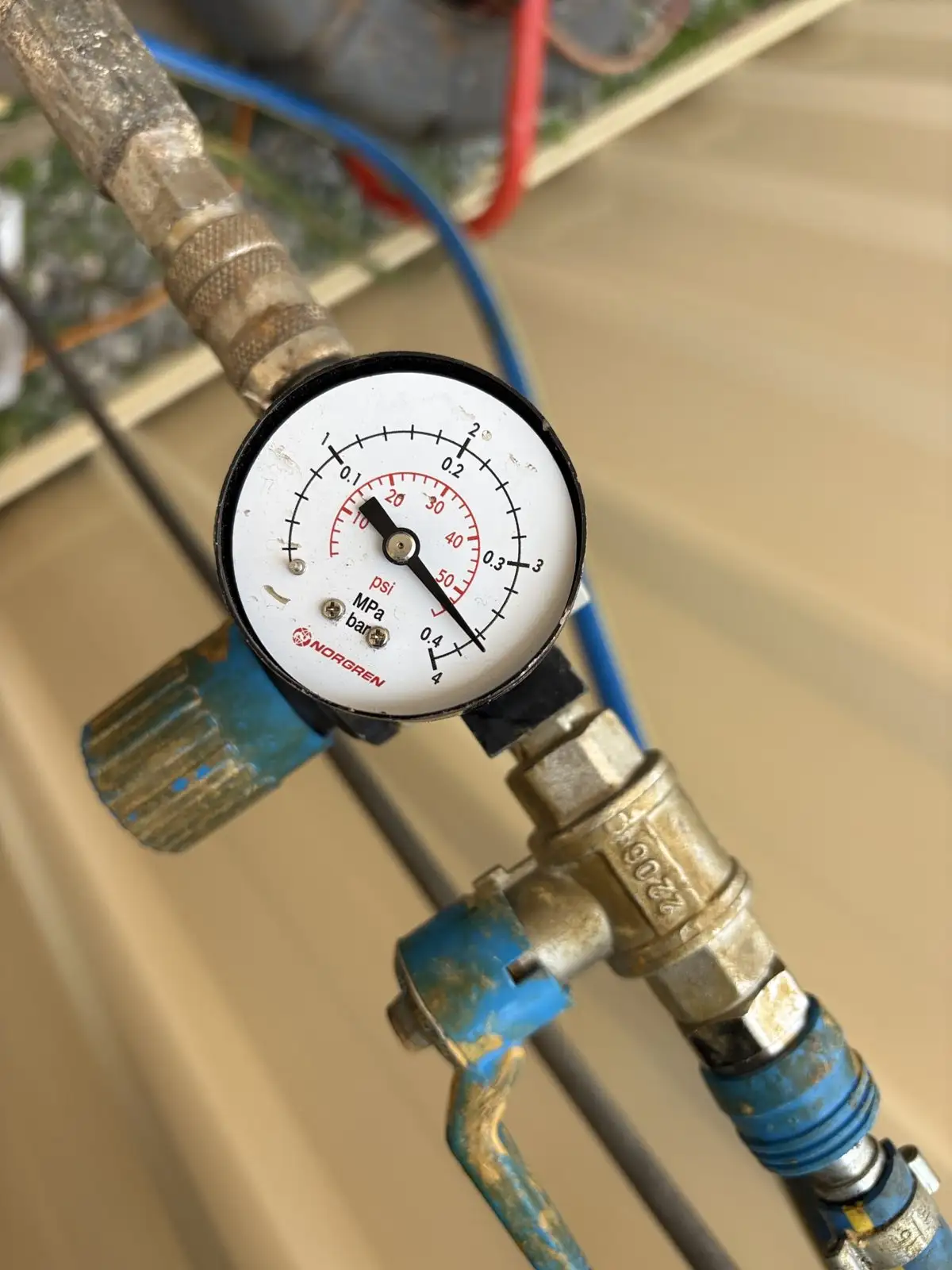 A pressure gauge on the relining rig during the Mandurah job, holding the liner against the pipe wall while it cures.