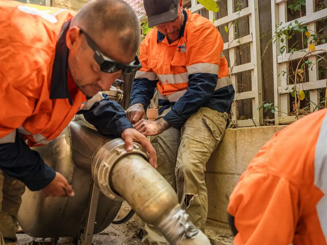 Crew members feeding a liner into the relining equipment.