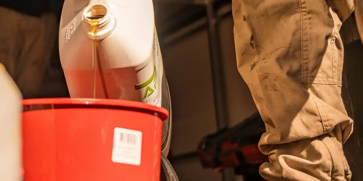 Resin being poured into a bucket while a pipe liner is prepared.